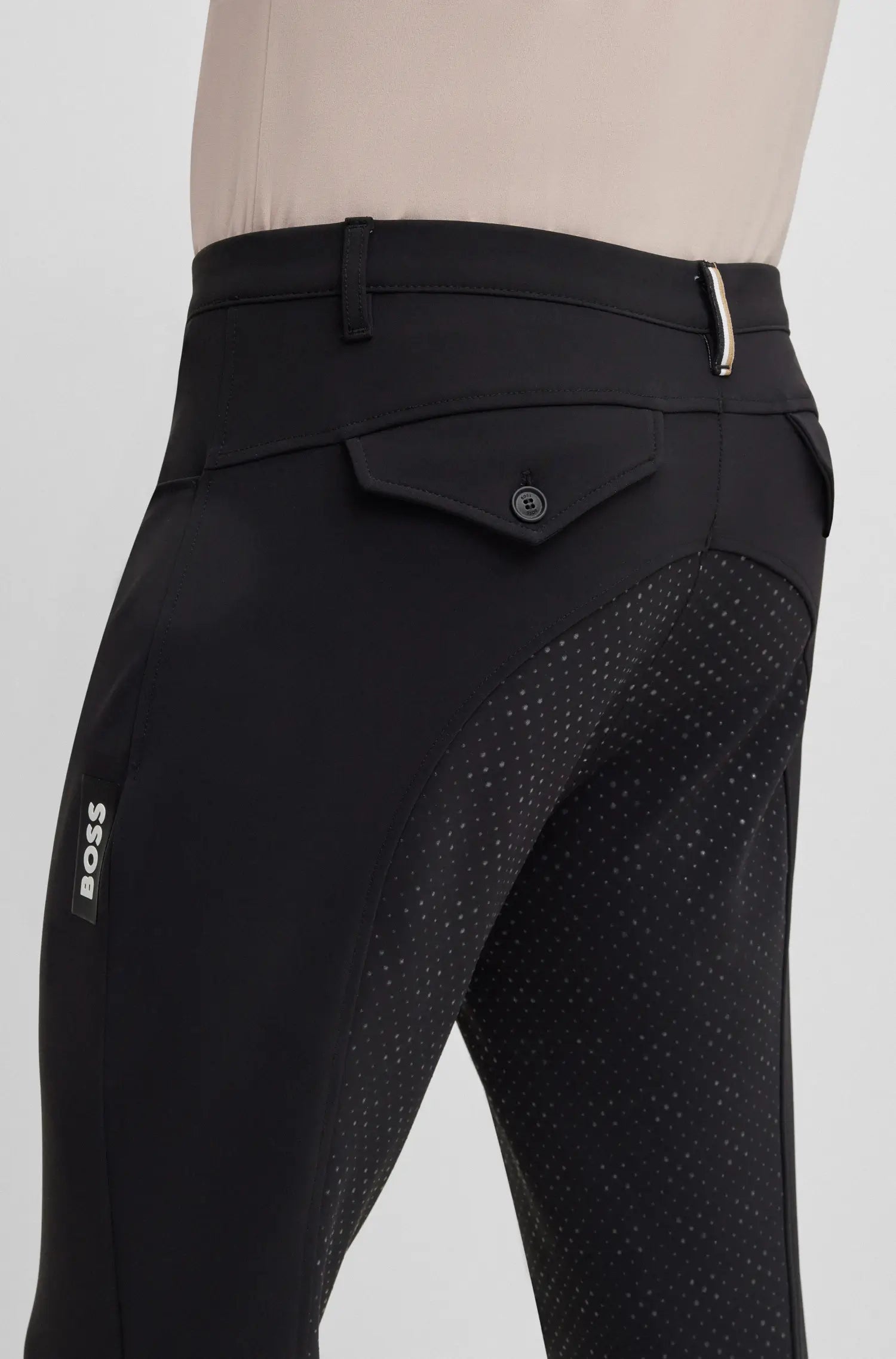 Black | Black equestrian pants with patterned seat area on a mannequin against a light gray background