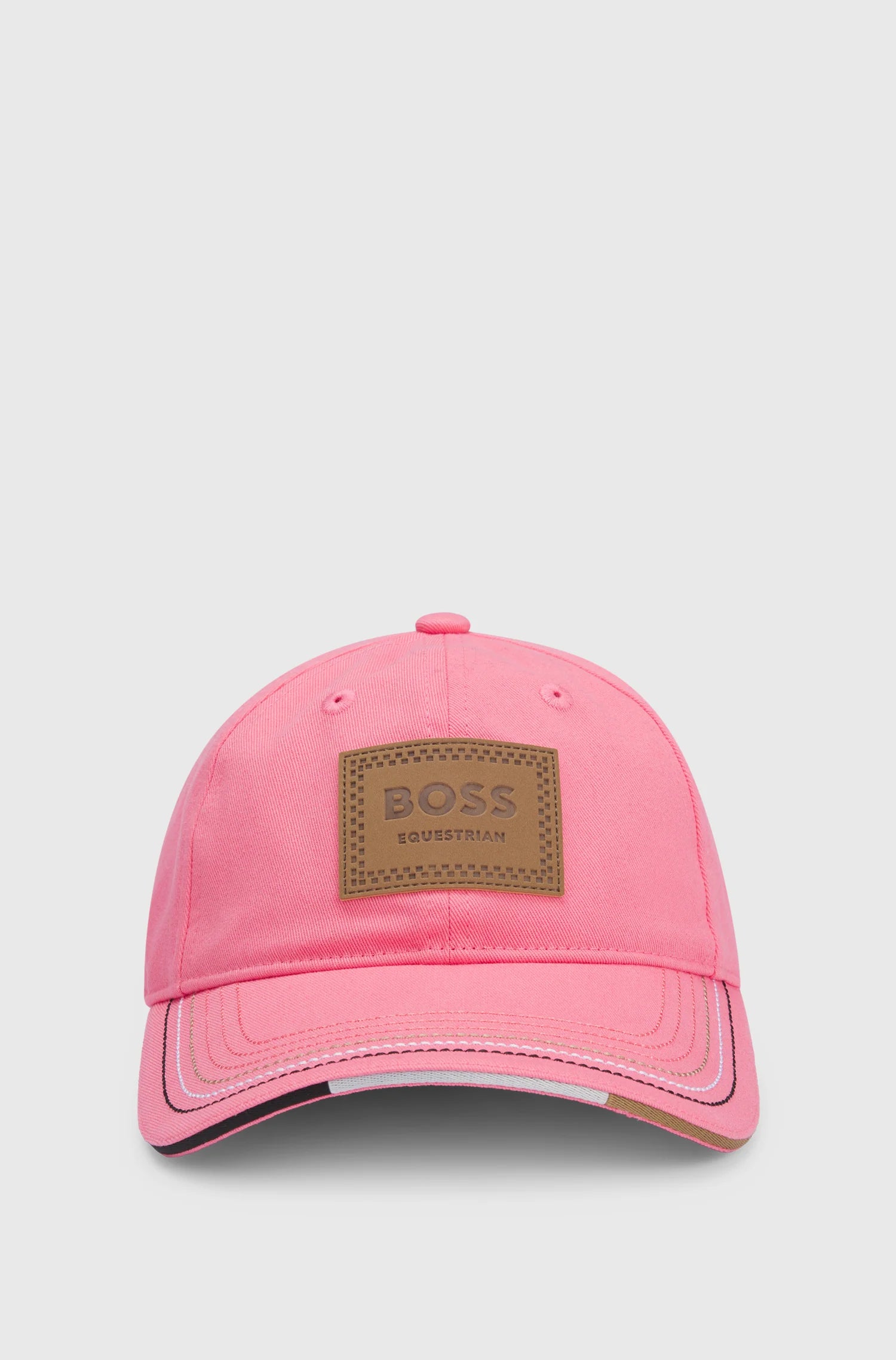 Pink | A pink baseball cap with a brown BOSS Equestrian patch on the front, photographed against a light gray background