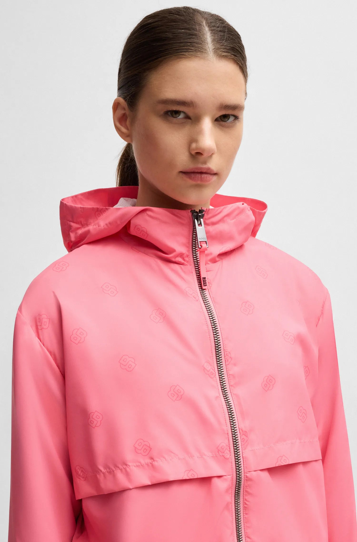 Pink | Person wearing a pink jacket on a light gray background