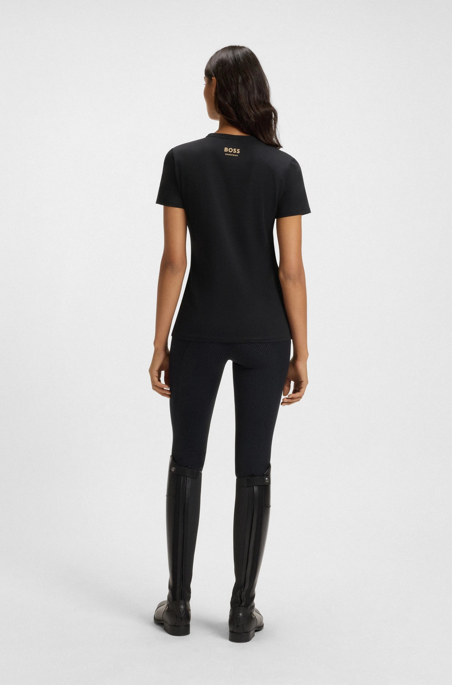 Black | Person wearing a black t-shirt and pants on a white background