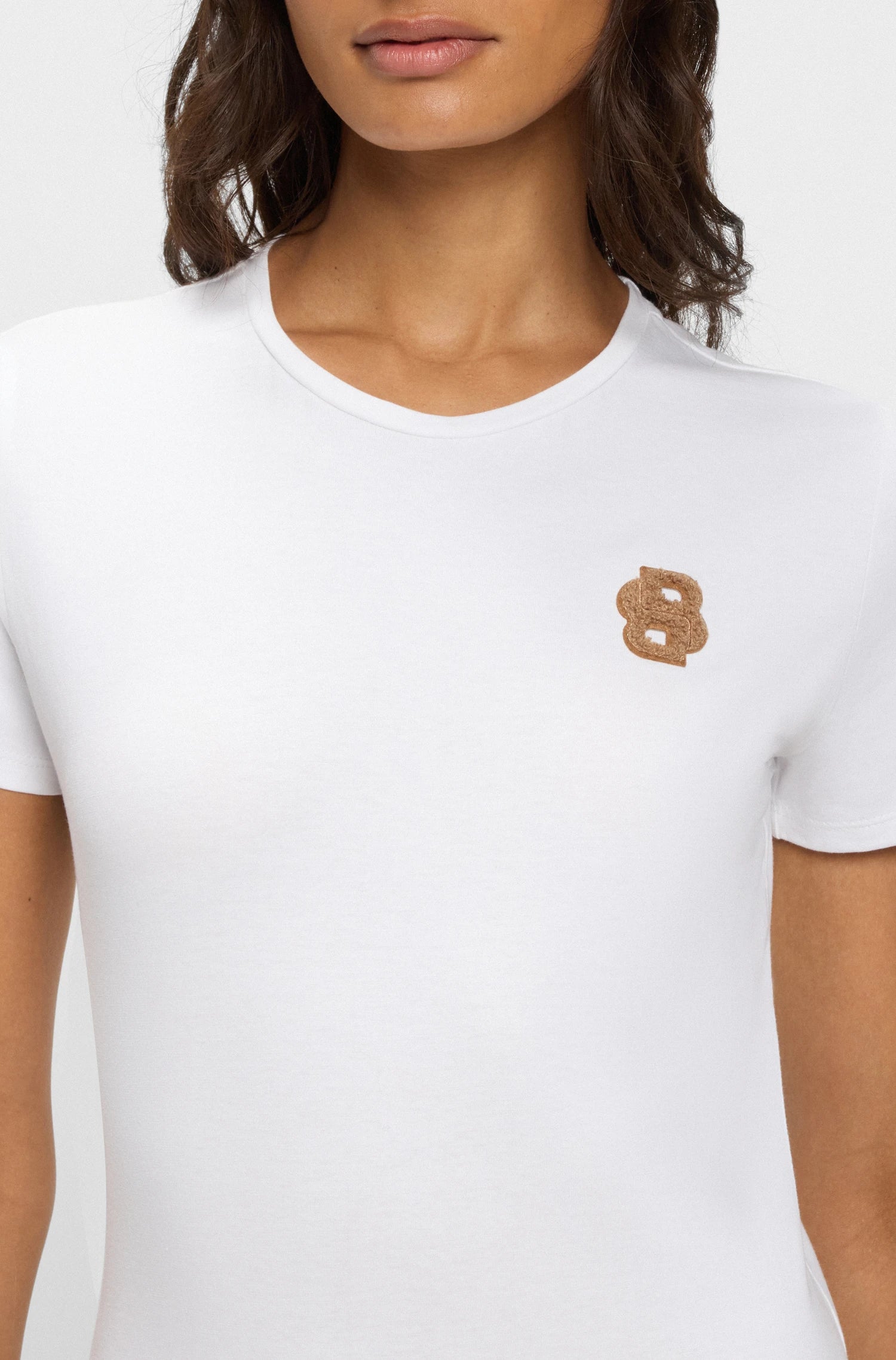 White | White t-shirt with a small logo on a plain background