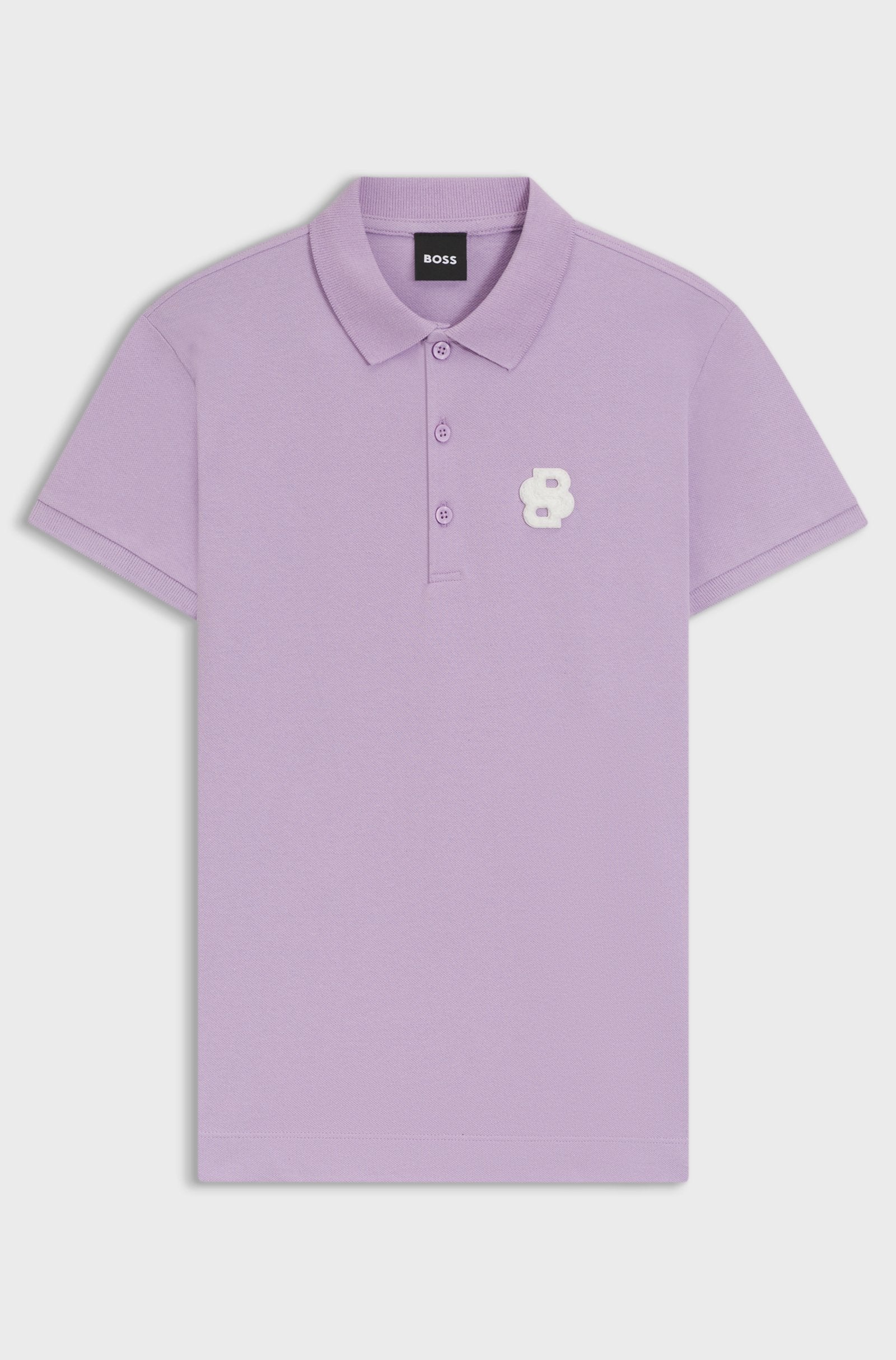 Orchid | A light purple short-sleeve polo shirt by BOSS, featuring a three-button placket and a small white embroidered flower logo on the left chest, displayed on a clean light gray background.